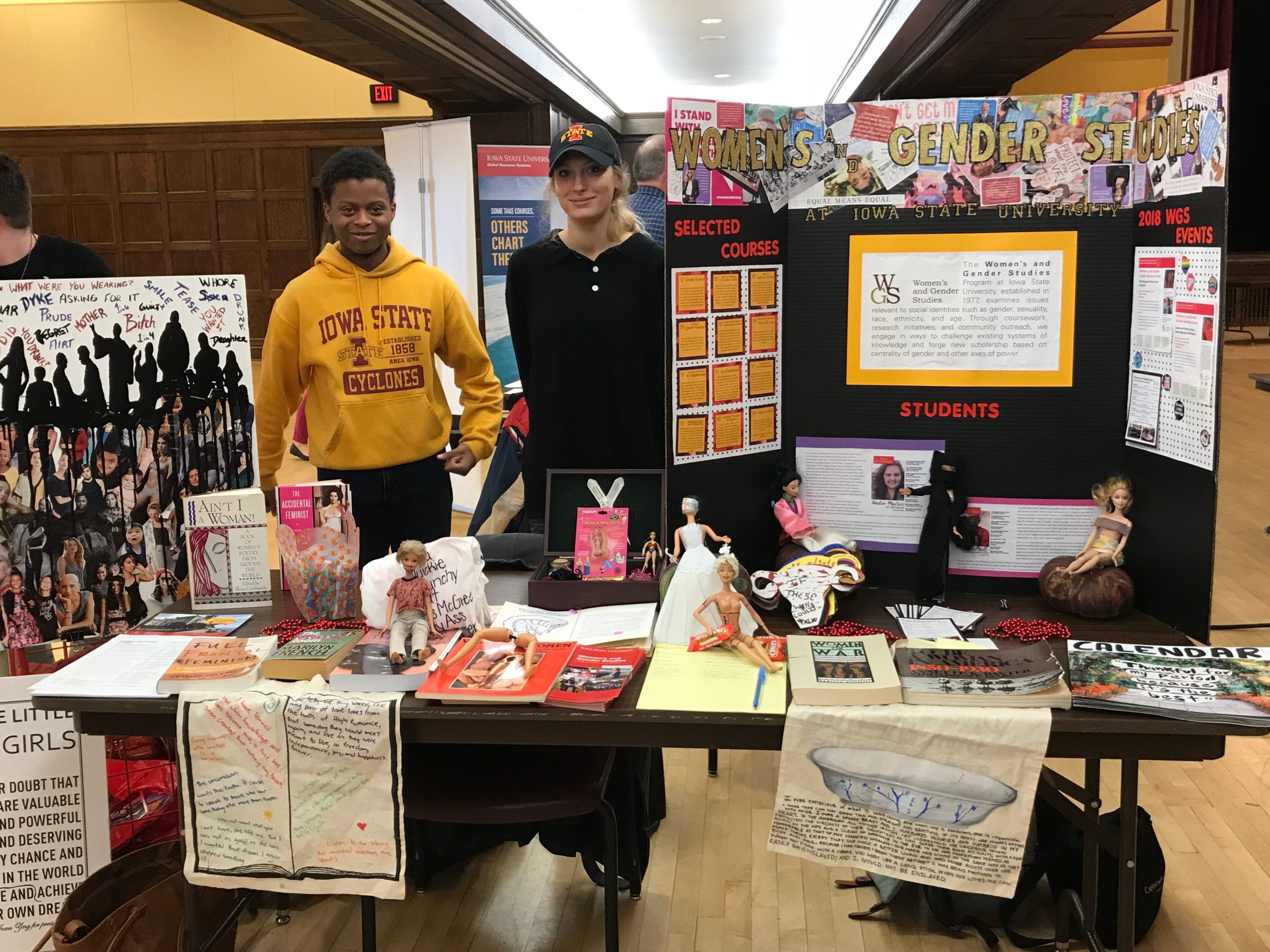 students in from of a womens and gender studies display